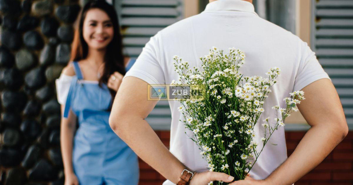A boy having flower behind him proposing the girl. anniversary image on zubne.com